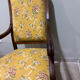 Louis XV style cabriolet armchair in solid wood, yellow floral fabric.