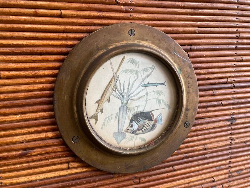 Rattan and wood bar with its decorative brass portholes