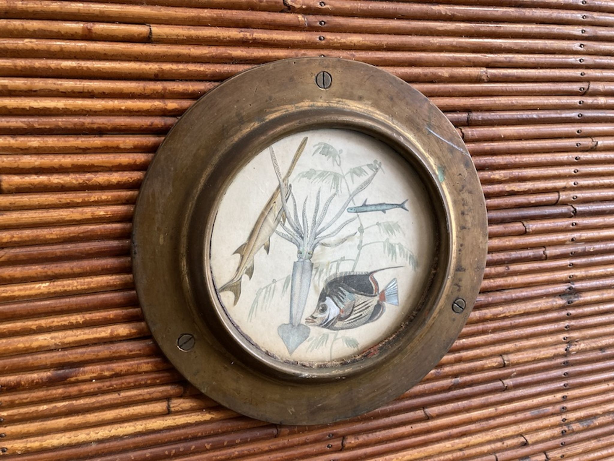 Rattan and wood bar with its decorative brass portholes