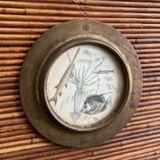 Rattan and wood bar with its decorative brass portholes