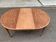 Renovated round extendable dining table made of solid mahogany from the 19th century.