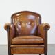 Sheep leather design armchair finished with decorative nails and black piping