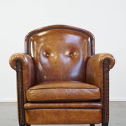 Sheep leather design armchair finished with decorative nails and black piping