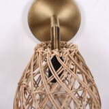 Golden bohemian wall lamp in woven rattan
