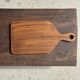 Rectangular solid teak chopping board with elongated handle 30x16.