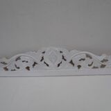 Decorative pediment in white carved wood