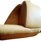 Pair of yellow leather swivel armchairs with asymmetrical armrests, circa 1980