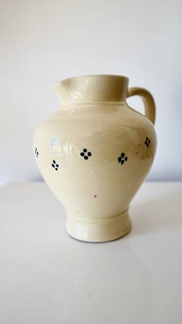 Vintage butter yellow ceramic pitcher in rustic style