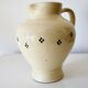 Vintage butter yellow ceramic pitcher in rustic style