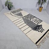 Handmade pure wool rug in black and white, size 150 x 250 cm.