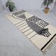 Handmade pure wool rug in black and white, size 150 x 250 cm.