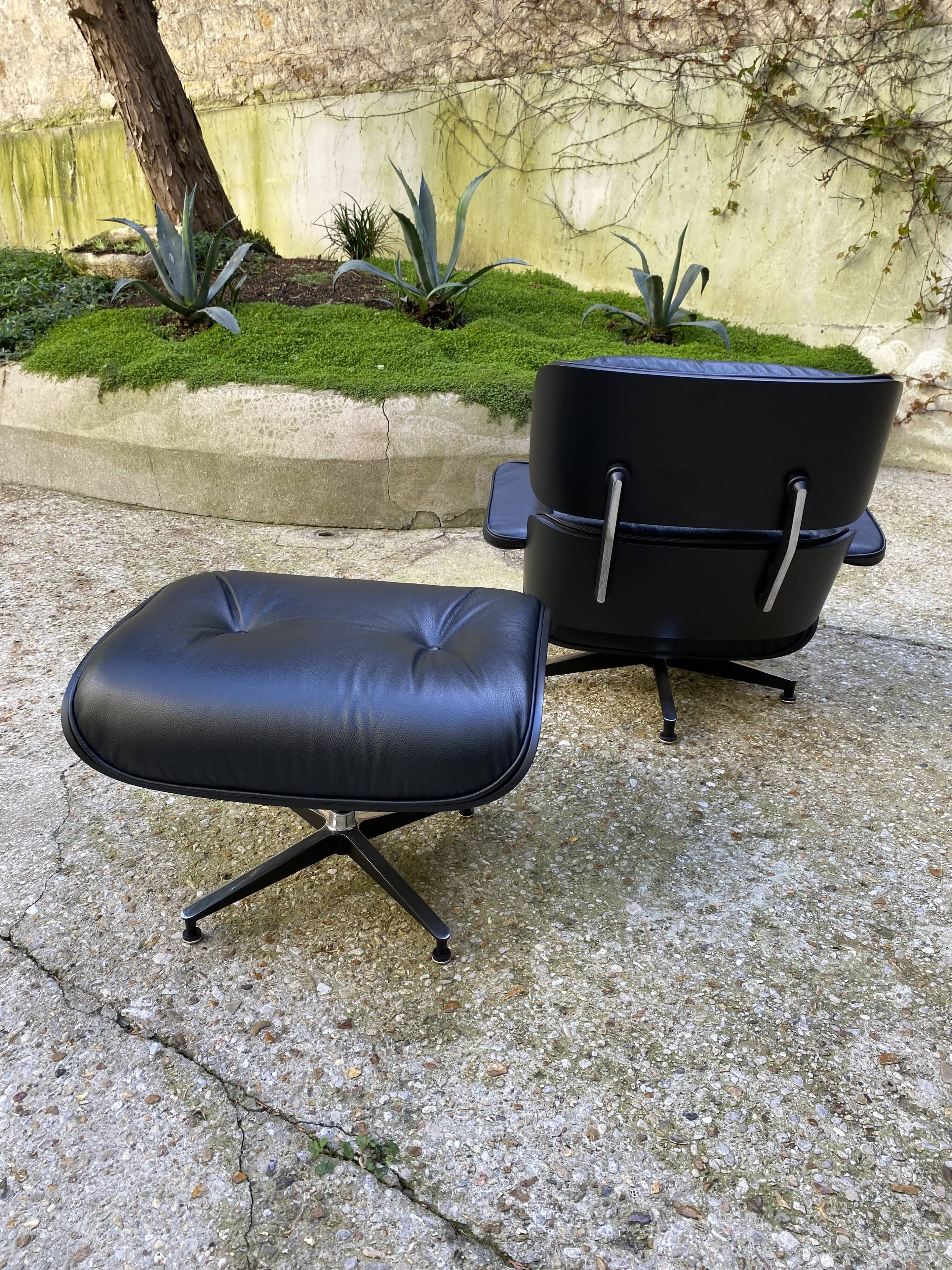 Charles Eames all-black lounge chair and ottoman, Herman Miller edition
