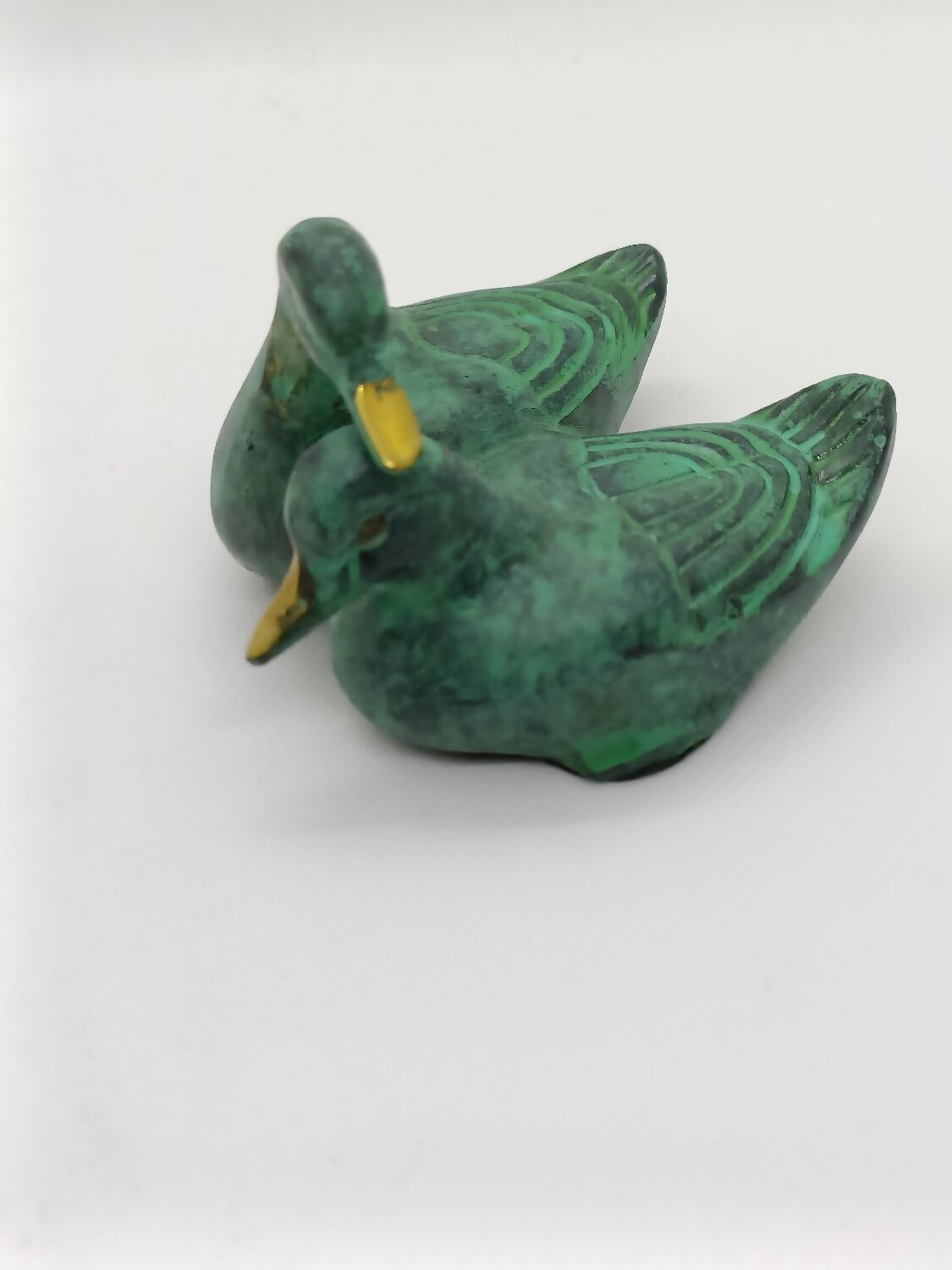 Two green and golden ducks in brass