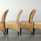 Ensemble de quatre chaises de salle à manger en cuir de vache avec un siège confortable et un dossier haut.