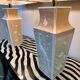 Pair of large cream ceramic table lamps with relief peacocks and fabric shades