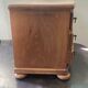 Blonde wooden doll's chest with brass handles.