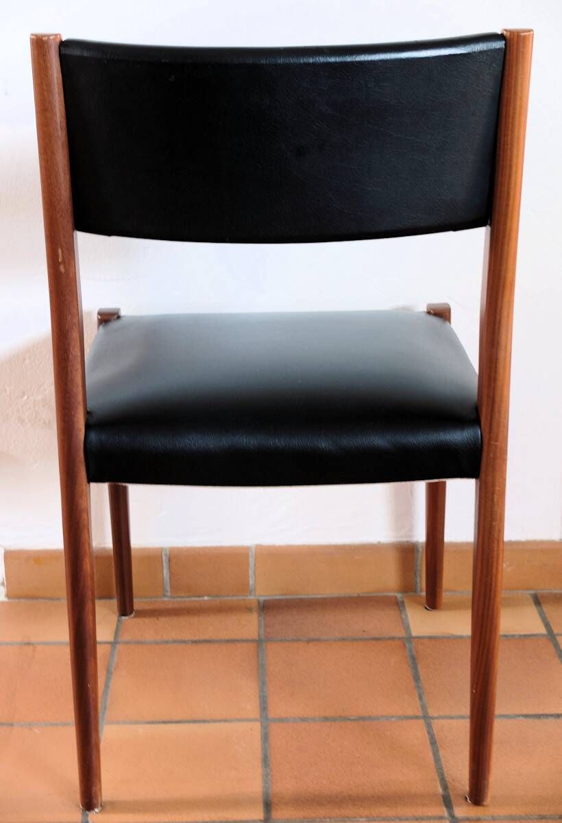 Four antique Scandinavian-style chairs made of solid wood and faux leather.