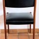 Four antique Scandinavian-style chairs made of solid wood and faux leather.