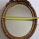 Louis xvi style oval mirror decorated with ribbons