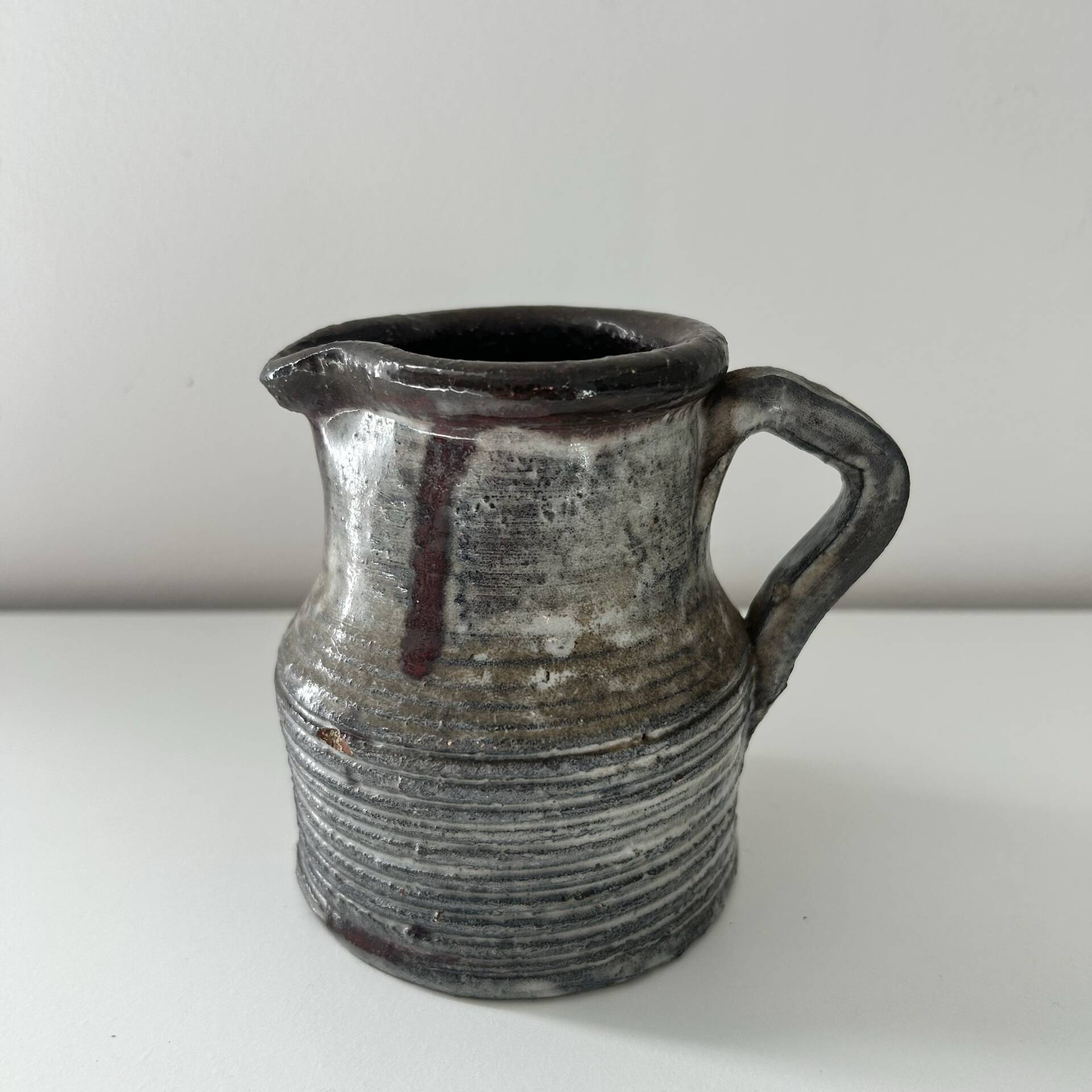 Patinated pitcher signed