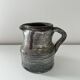 Patinated pitcher signed