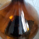 Great old demijohn in amber glass