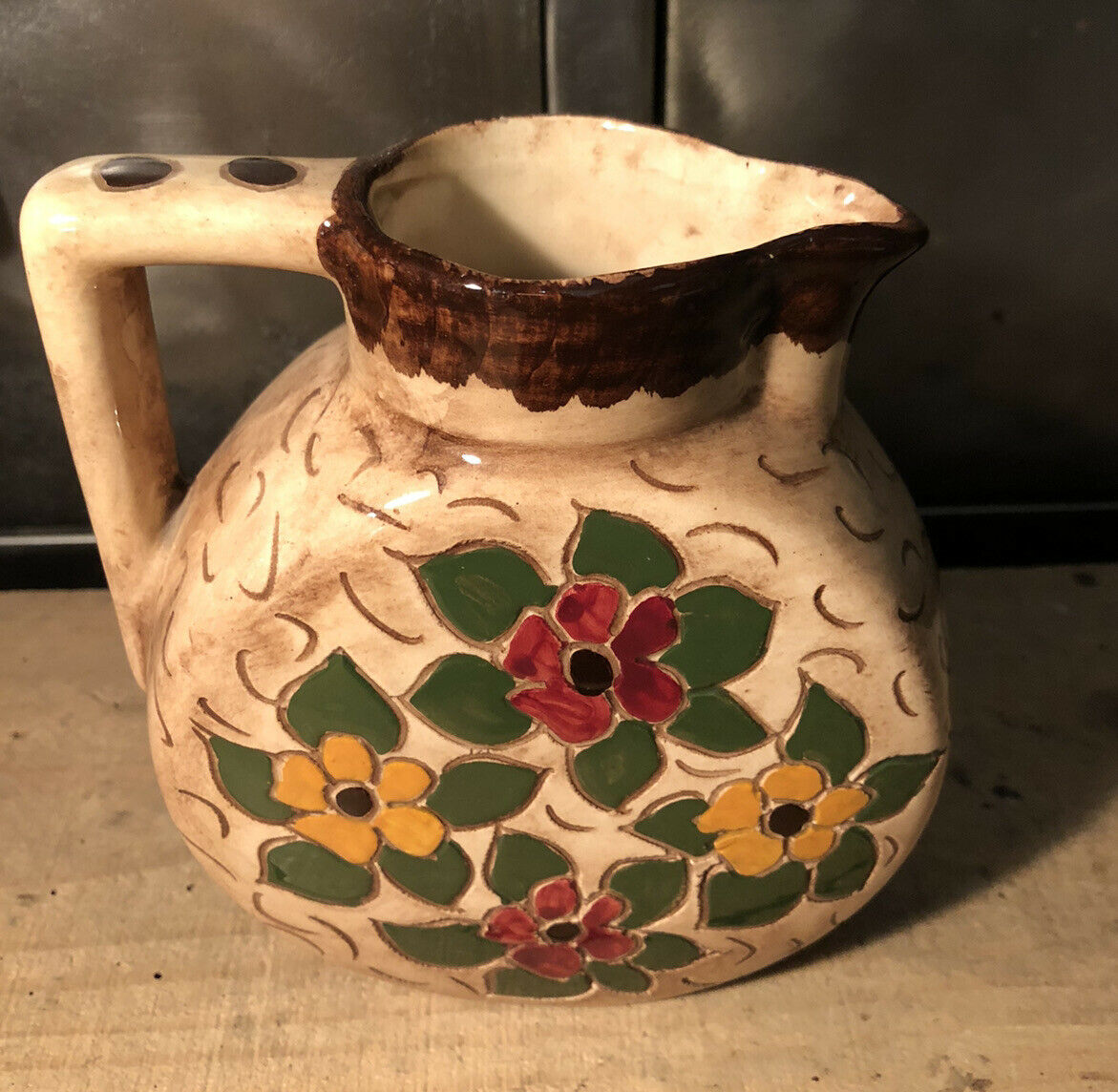 Ceramic pitcher with floral decoration signed Lucq