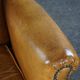 Old wingback armchair made of sheep leather in a correct condition