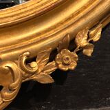 Golden oval mirror