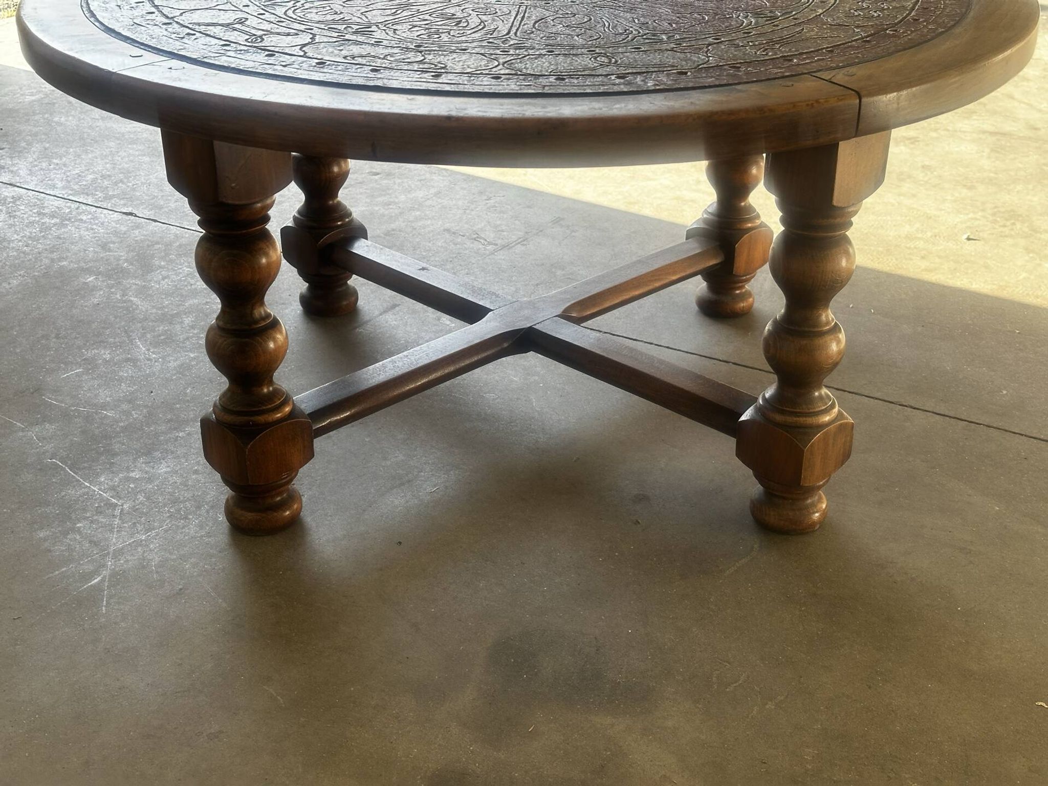 Vintage wooden turned coffee table with leather and astrological decoration.