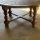 Vintage coffee table in turned wood and leather with astrological decoration.