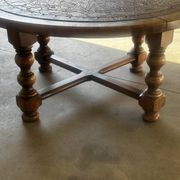 Vintage wooden turned coffee table with leather and astrological decoration.