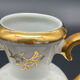 Small amphora vase in Limoges porcelain with gilded handles.