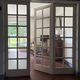 Triptych glass door with three panels featuring small panes. Vintage.