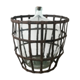 Old demijohn and her metal basket