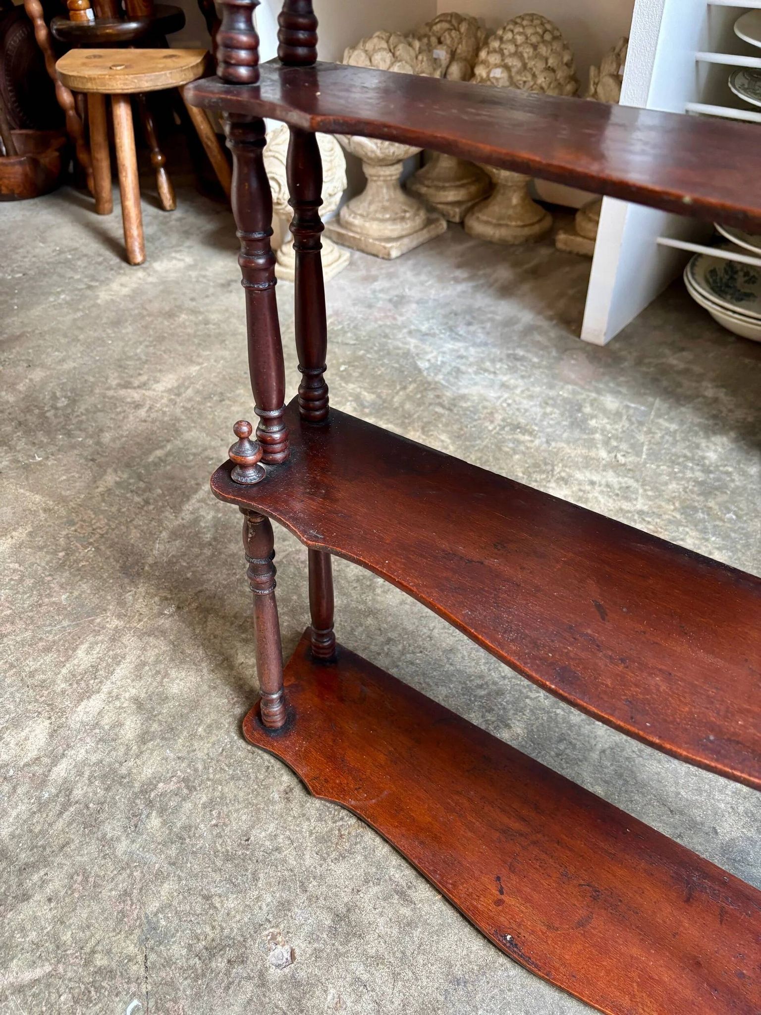 Curved and turned wooden wall shelf