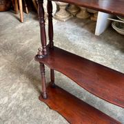 Curved and turned wooden wall shelf