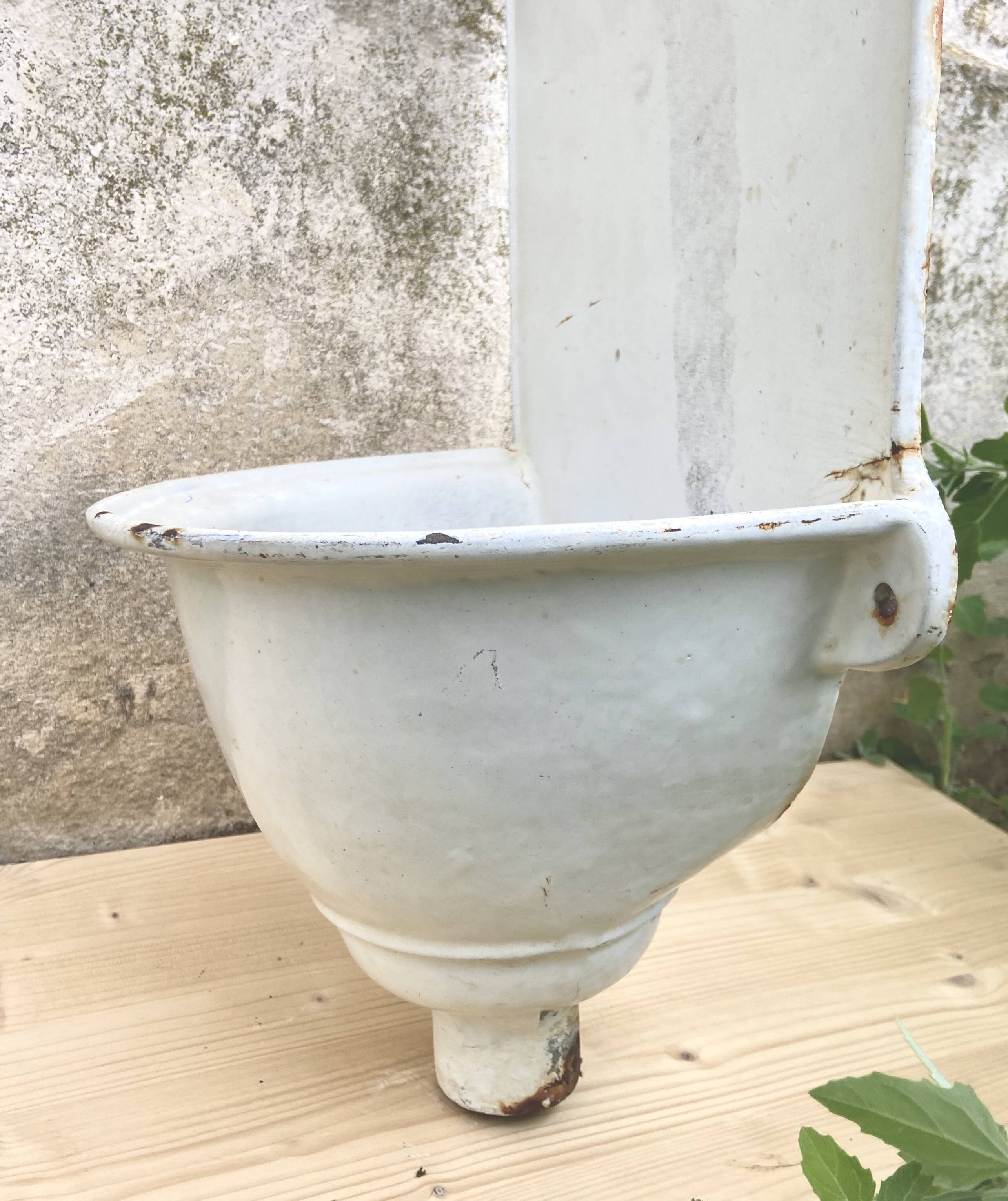 White enameled cast iron wall fountain