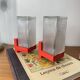 Pair of vintage wall lights in red plastic and clear glass.