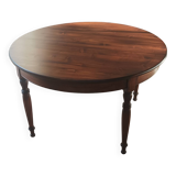 Round pine table with three extensions.
