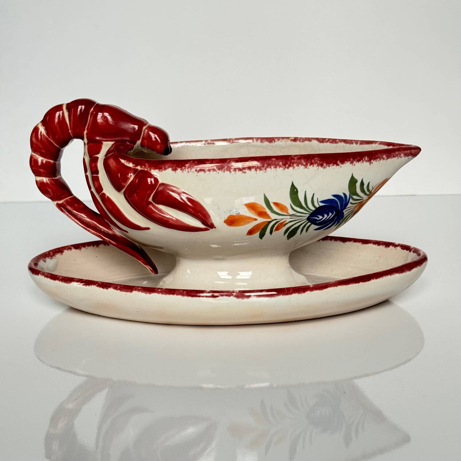 Henriot Quimper sauceboat – flower decoration & lobster-shaped handle