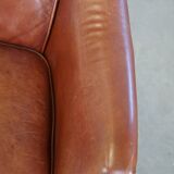 Cowhide armchair in good condition, finished with decorative nails