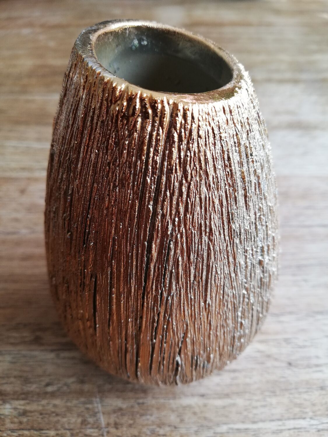 Small asymmetrical golden seed-shaped vase