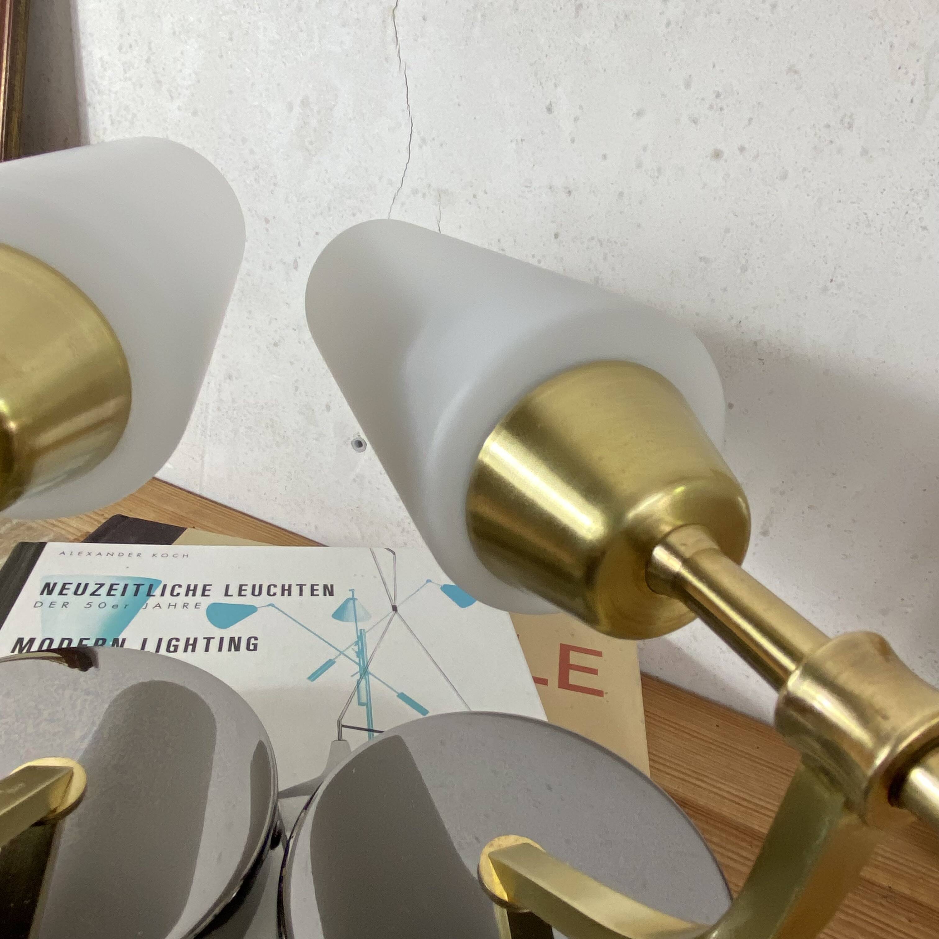 Pair of wall sconces in brass with white glass tulips.