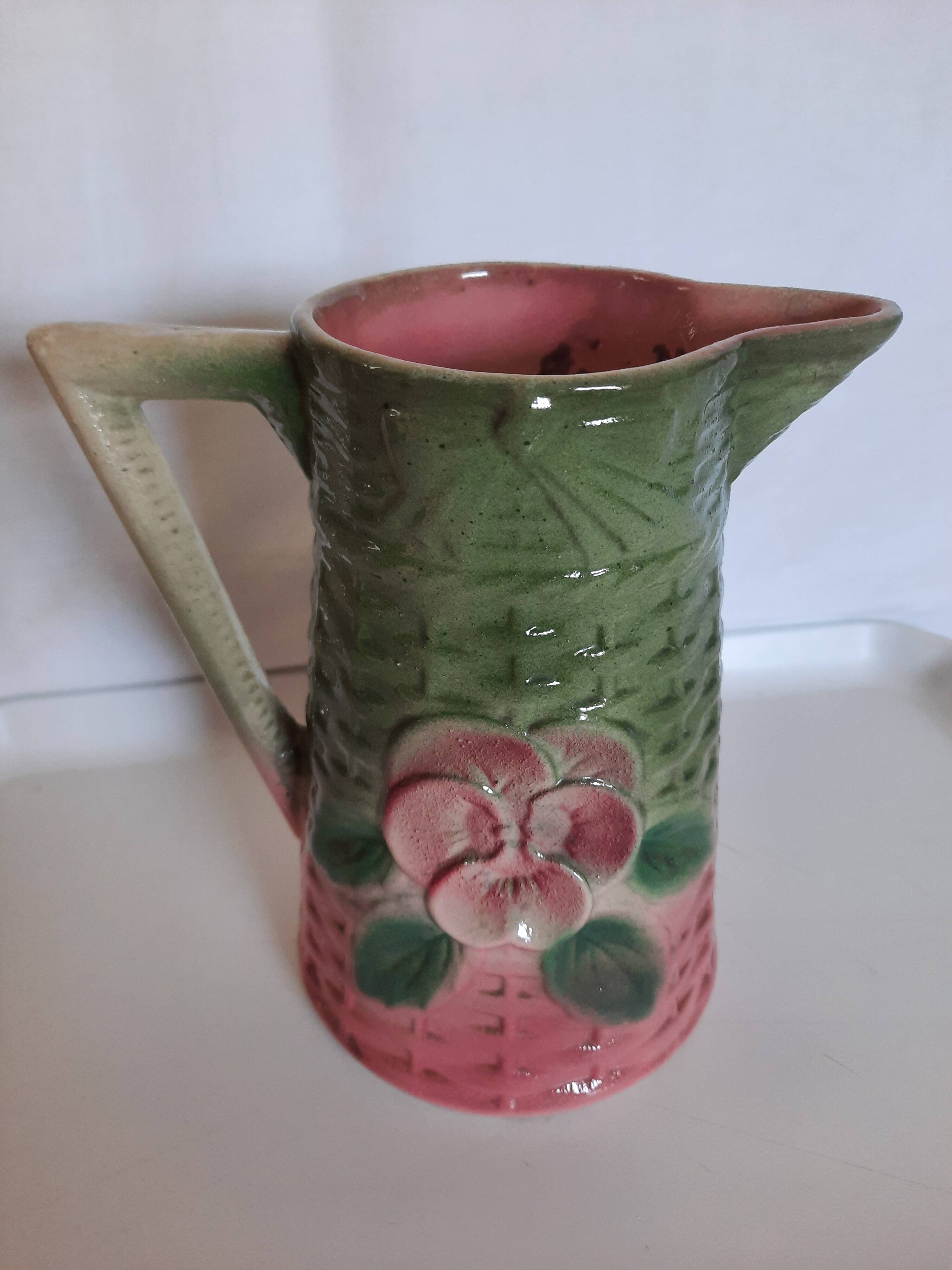 Slush pitcher. Pansy pattern on wicker basket background. Green and pink.
