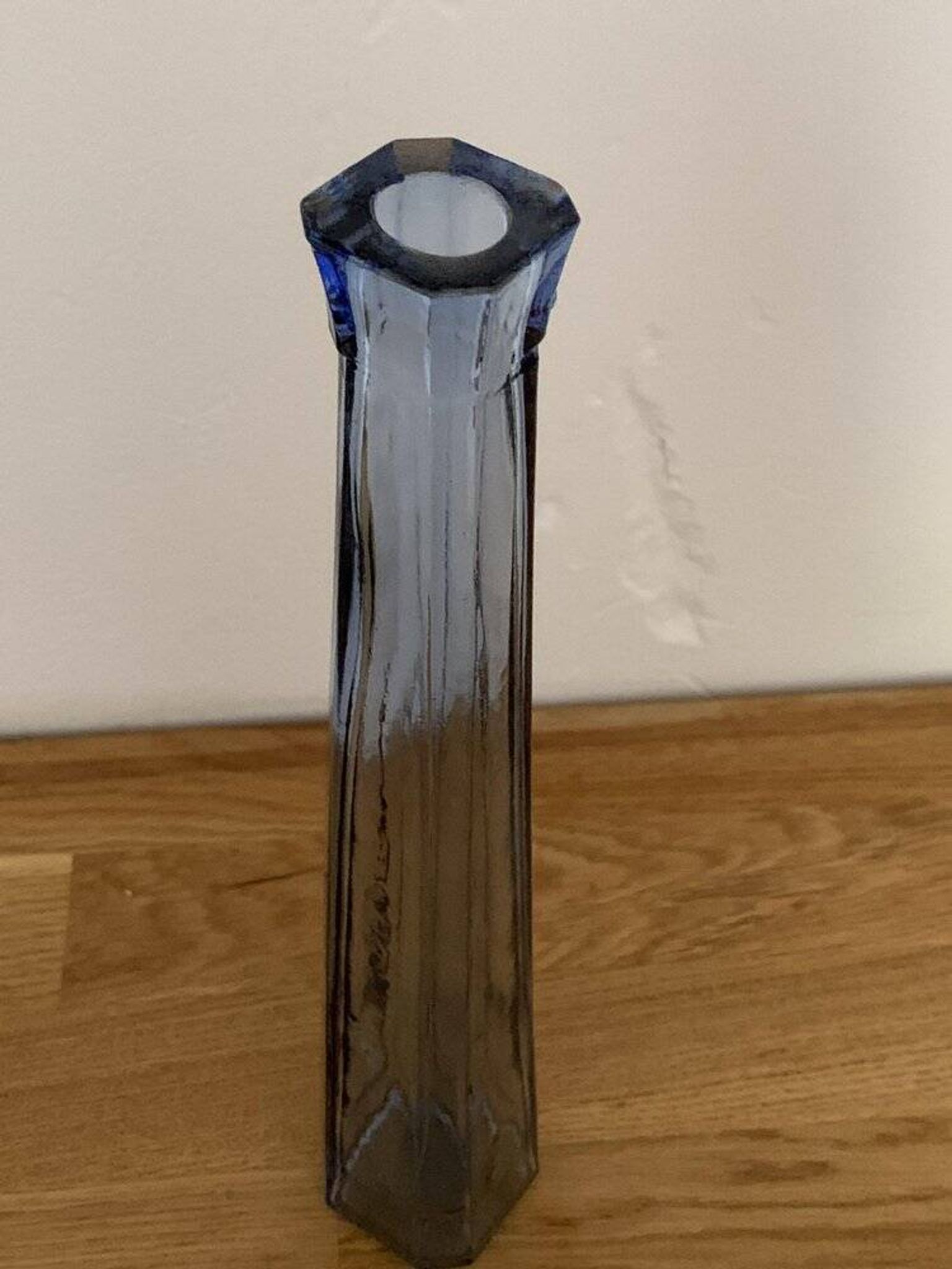 Translucent blue glass vase from the 1980s — tall prismatic silhouette, polygonal base.