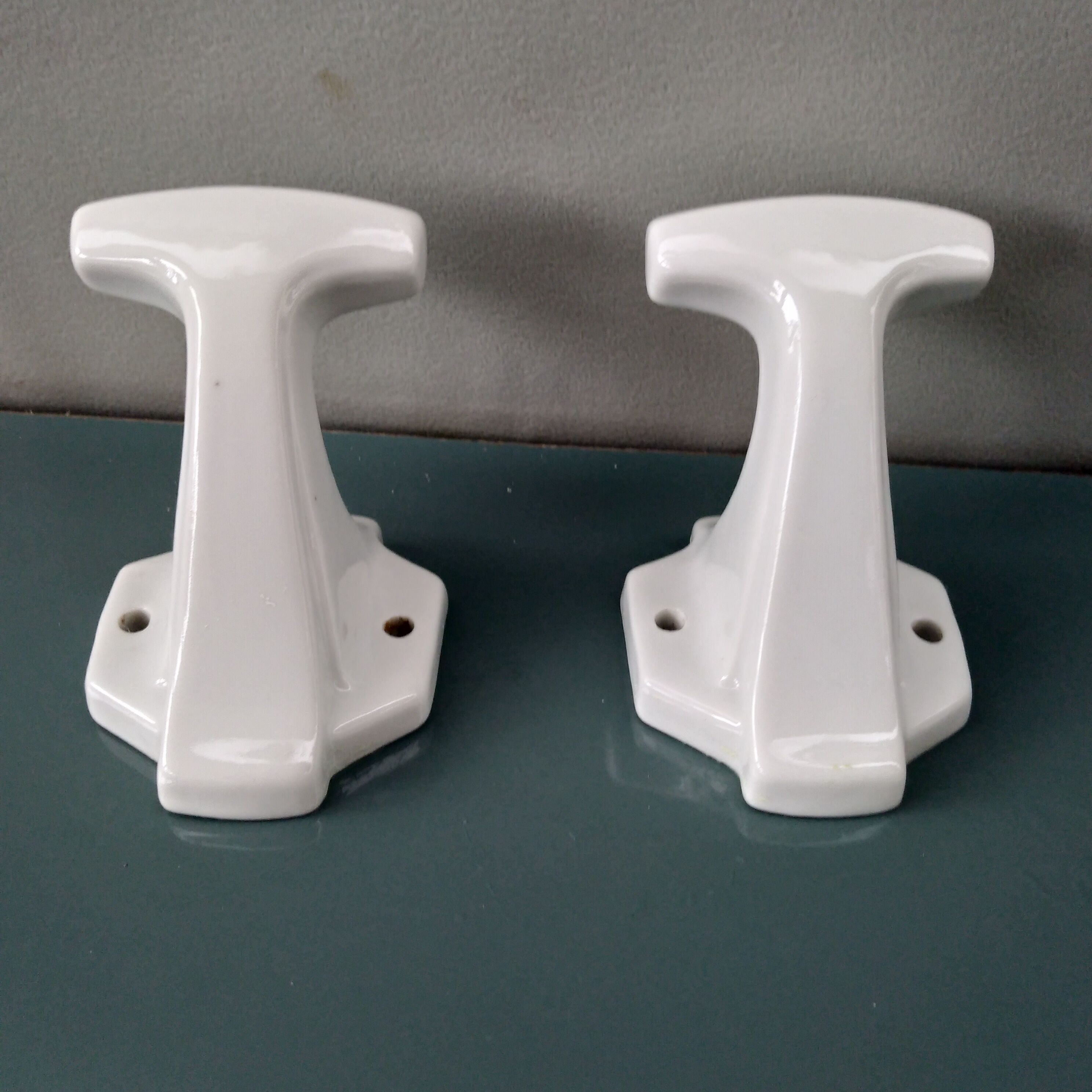 Pair of art deco porcelain coat racks