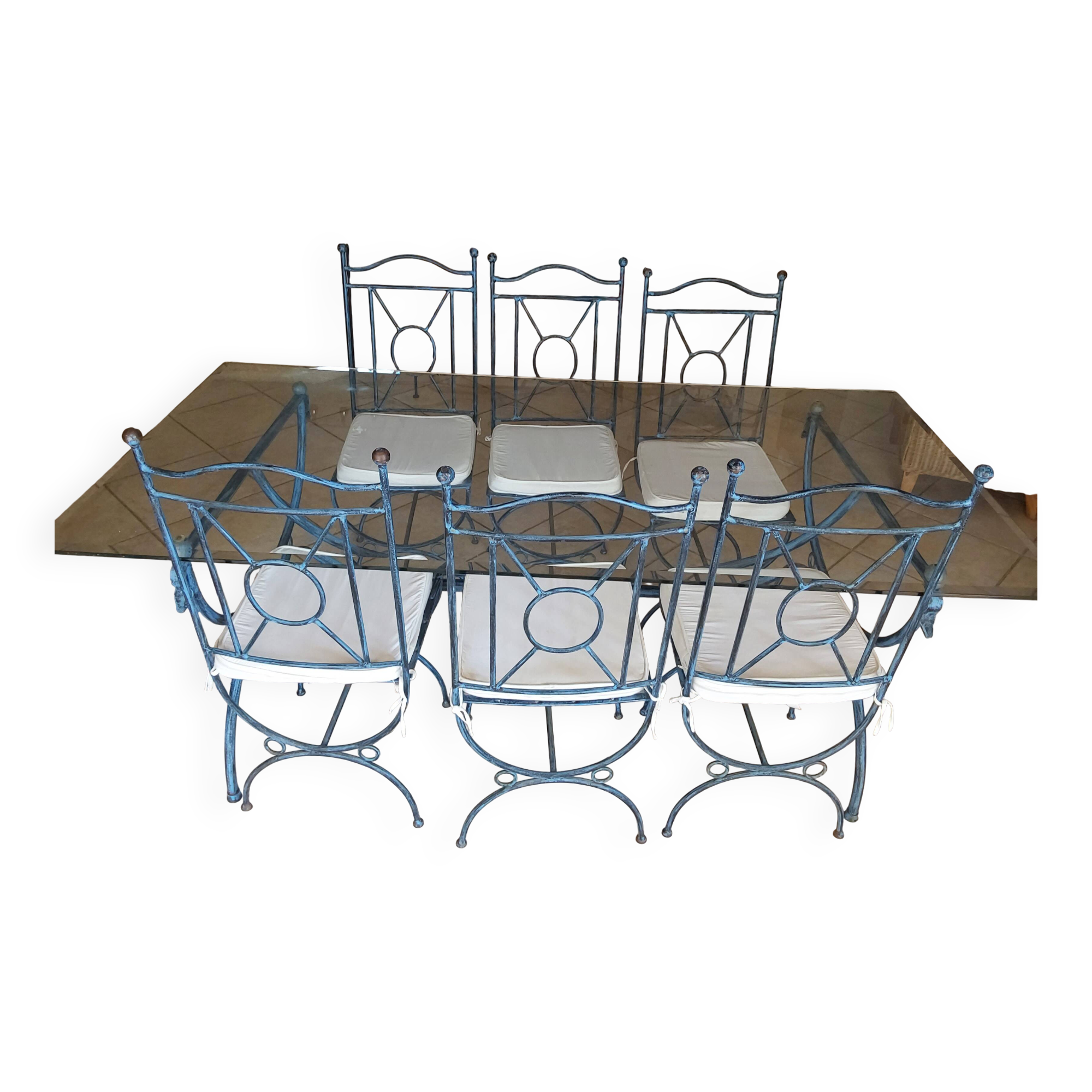 Wrought iron and bevelled glass table with 6 matching chairs.