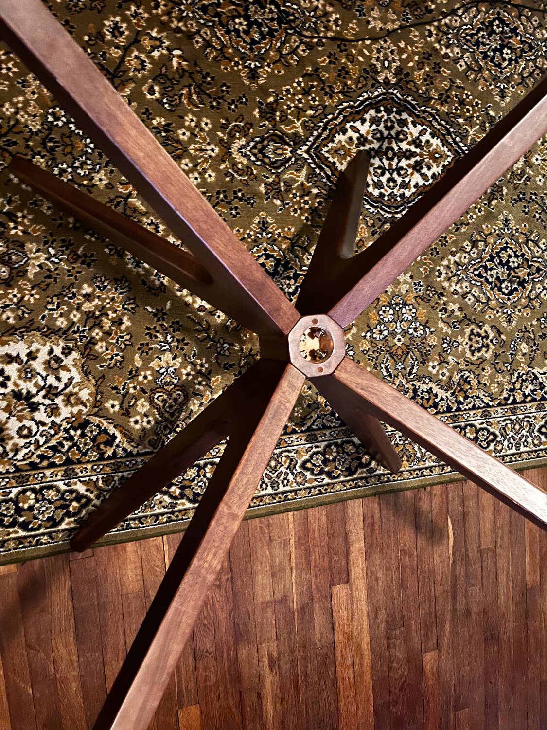 Round table made of solid wood with a walnut finish top.