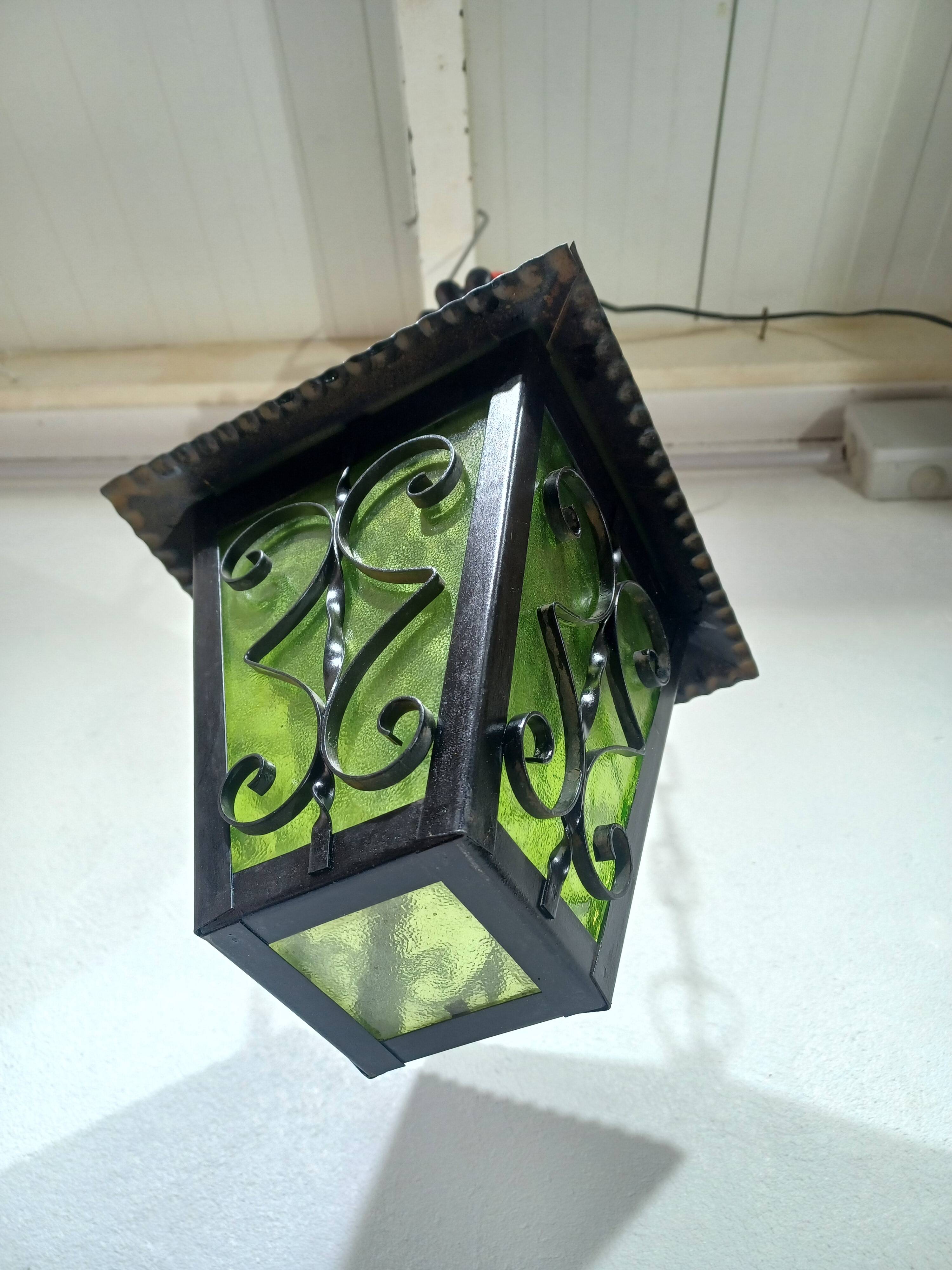 Wrought iron and green glass lantern